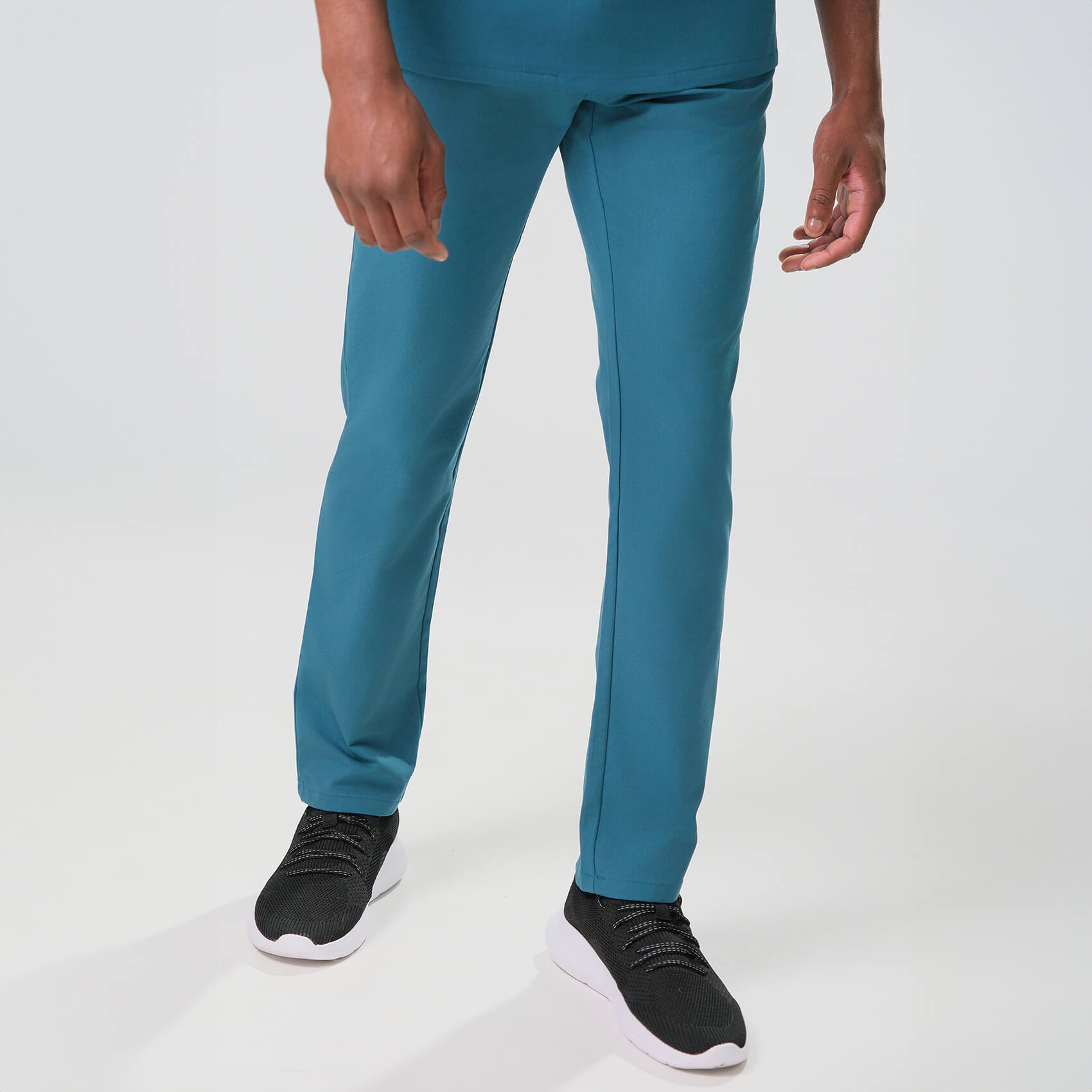 men's green scrub trousers worn on a white background