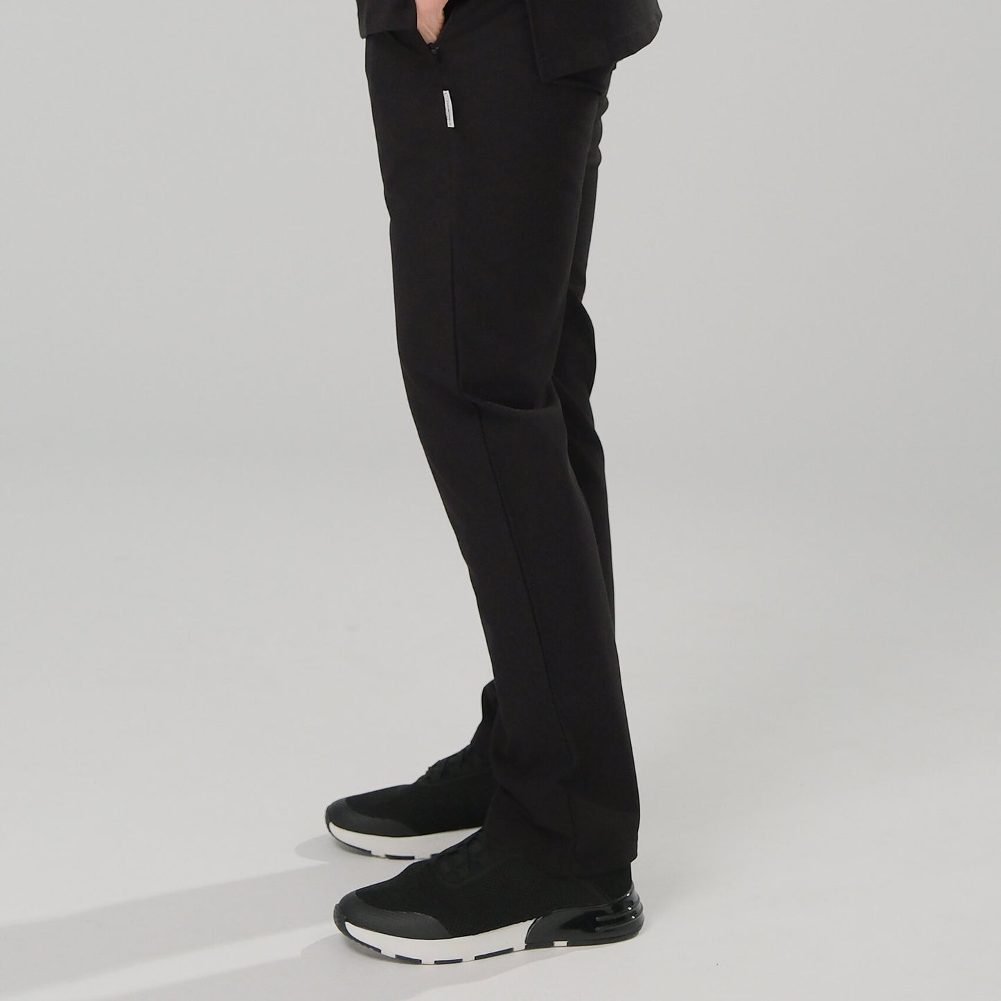 lady wearing black scrub trousers and black shoes